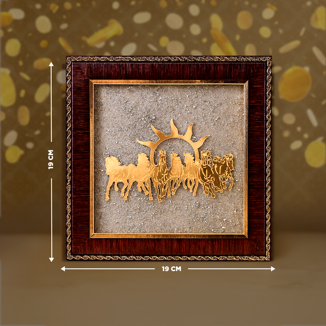 Decorative wall art with a gold horse and carriage design in a wooden frame, on a brown background.7 Horses Raw Pyrite Frame - Vastu Success & Wealth Frame