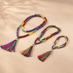 Colorful beaded necklace with tassels on a beige background