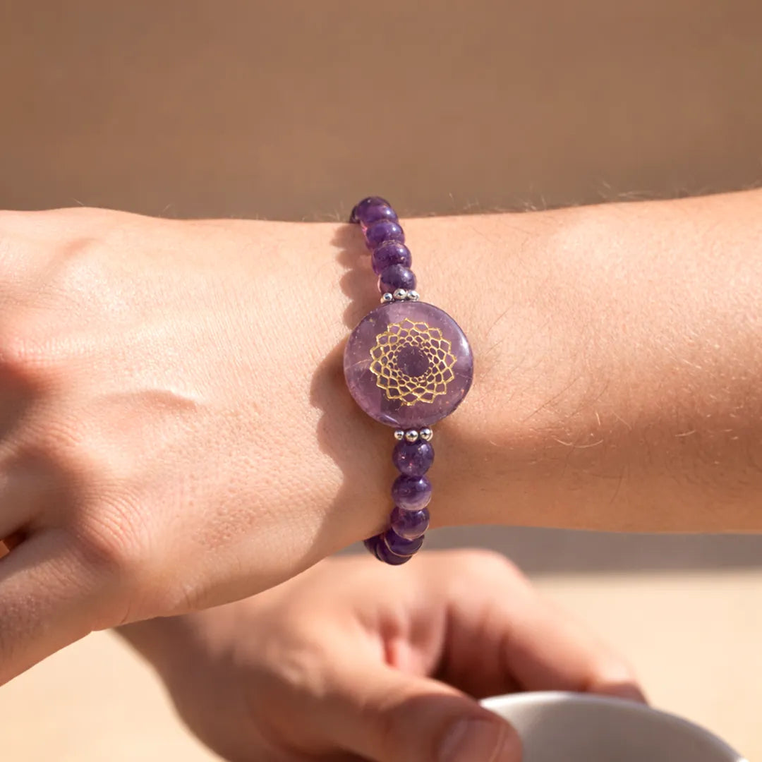 Purple beaded bracelet with a circular design on a wrist against a neutral background