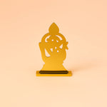 Gold decorative item on a peach background