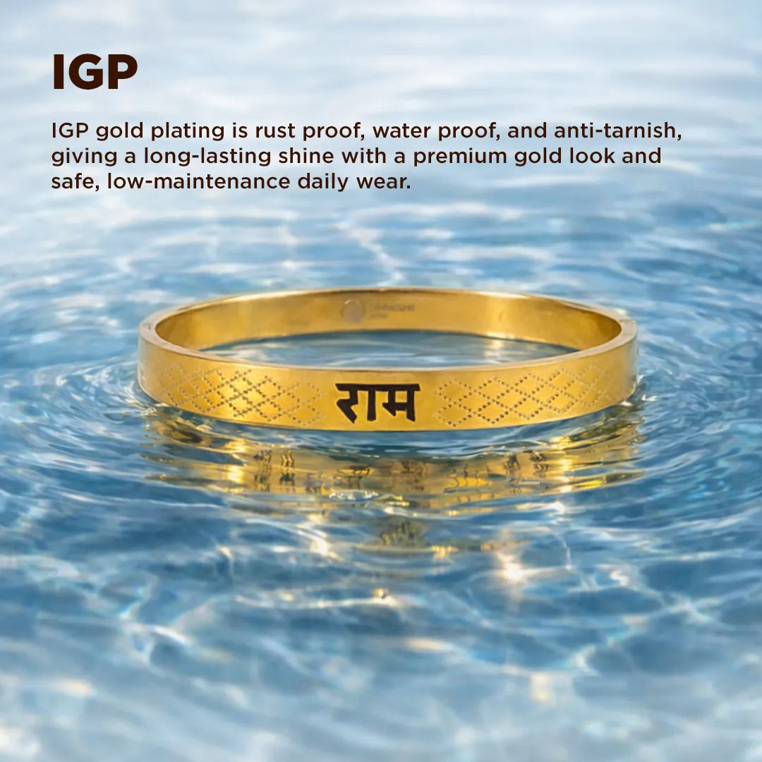 Gold bracelet with engraved text floating in water, featuring IGP gold plating information.