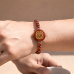 Bracelet with a circular design on a wrist against a neutral background