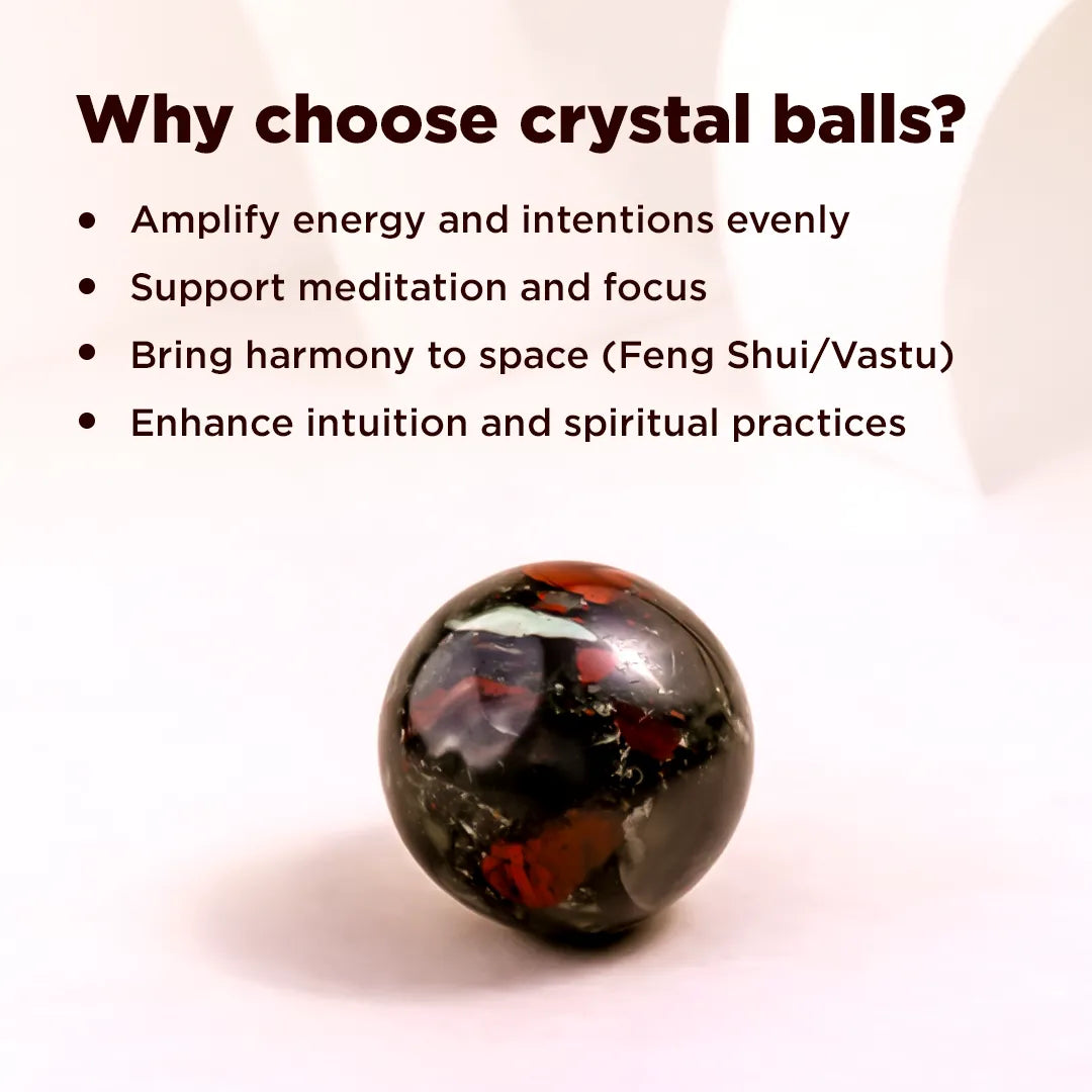 Crystal ball with text explaining benefits on a light pink backgroundNatural Blood Stone Crystal Ball – Abhimantrit & Certified