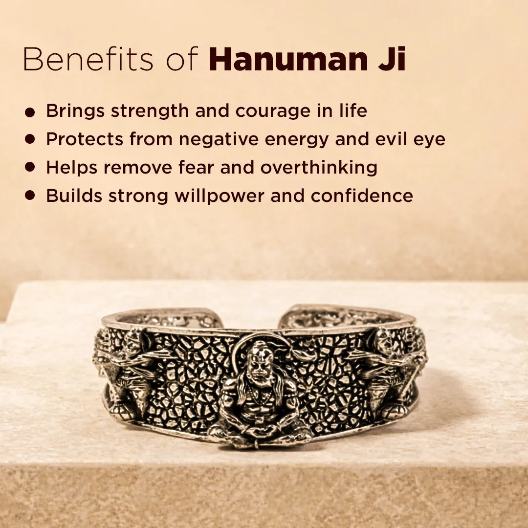 Silver bracelet with engravings on a wooden surface, featuring text about the benefits of Hanuman Ji.Hanuman Ji Kada – Silver Oxidized Spiritual Kada for Strength, Protection & Courage