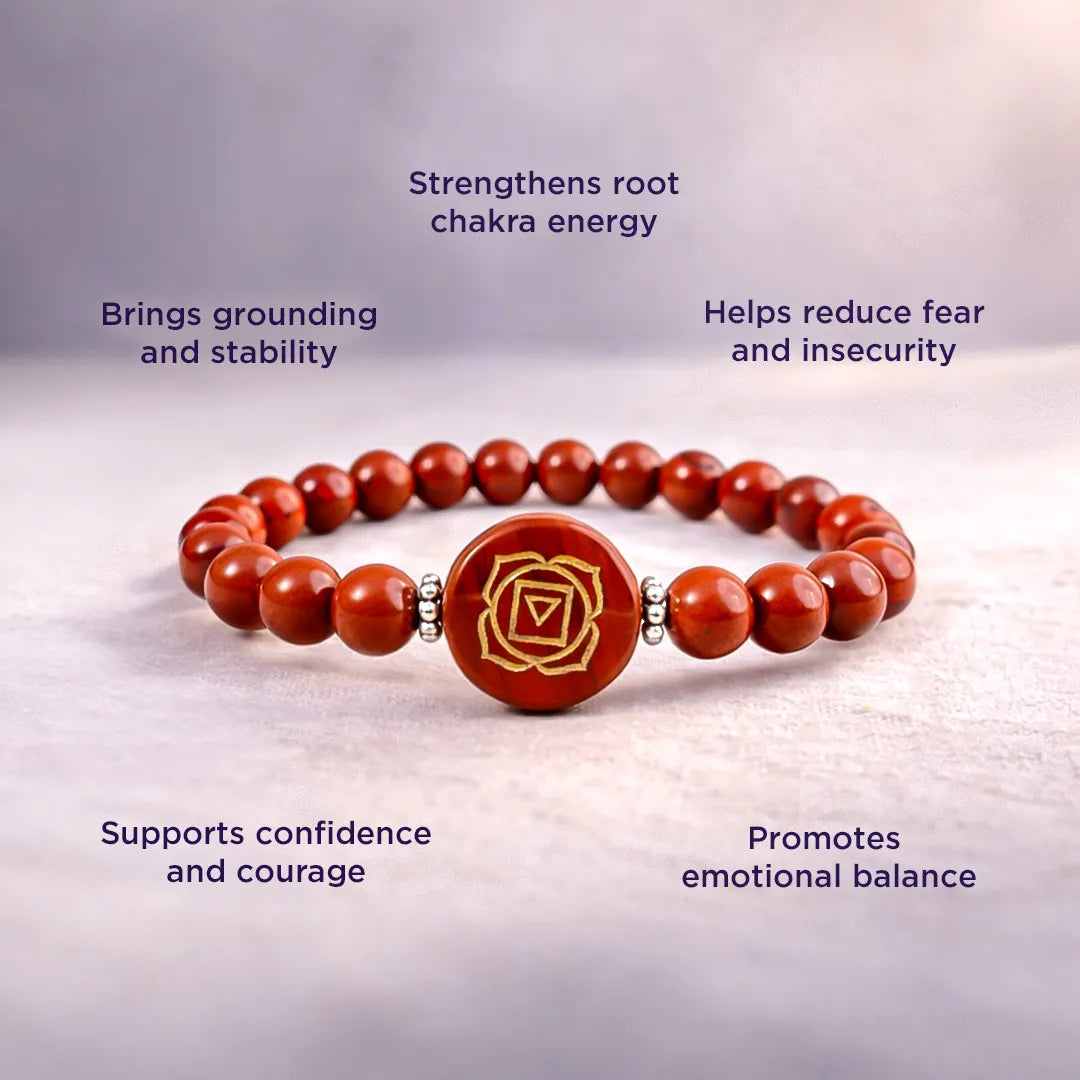 Red beaded bracelet with a central emblem on a light background, featuring text about its benefits.Red Jasper Root Chakra Bracelet – Abhimantrit & Energized