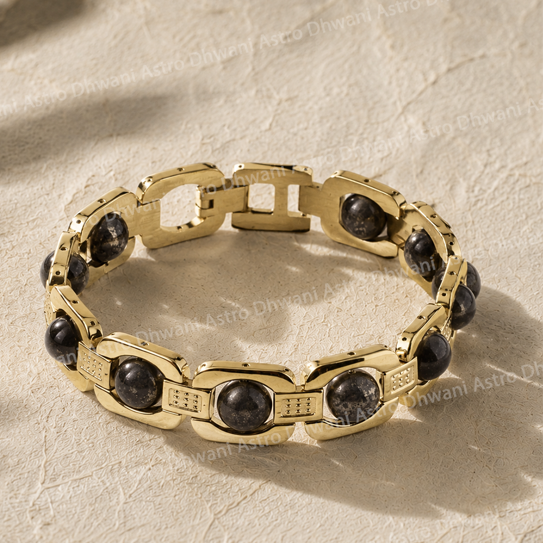 Gold chain bracelet with black stones on a beige textured backgroundNatural Pyrite Stone Chain Bracelet for Prosperity & Confidence