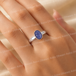 Silver ring with a blue gemstone on a hand