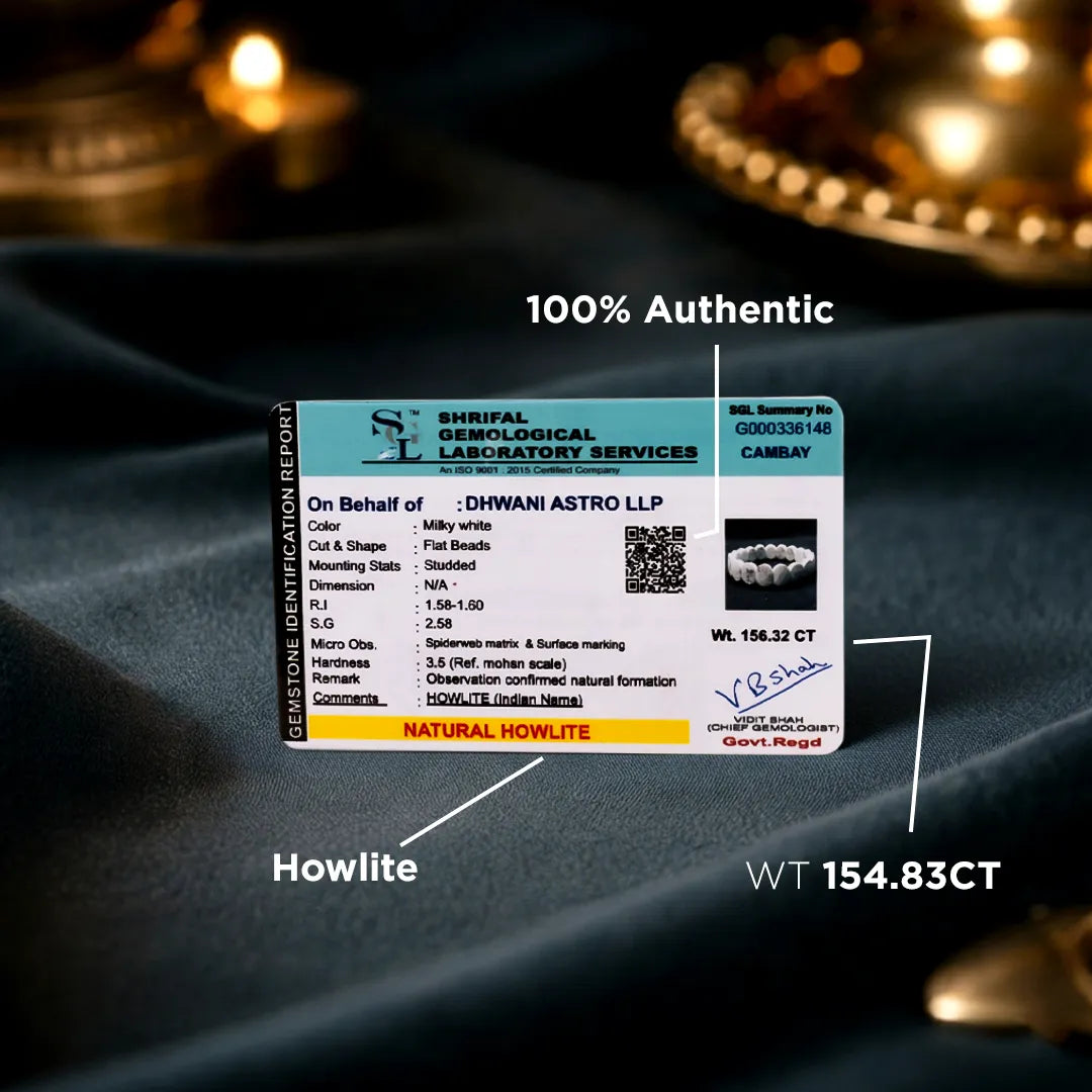 Certification card for a gemstone on a dark fabric background with candles.