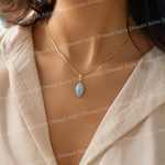 Necklace with a blue pendant worn by a person, with 'Astro Dhwani' branding in the background.