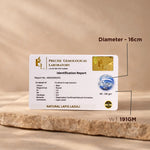 Precise Gemological Laboratory identification report card for natural lapis lazuli on a wooden surface.