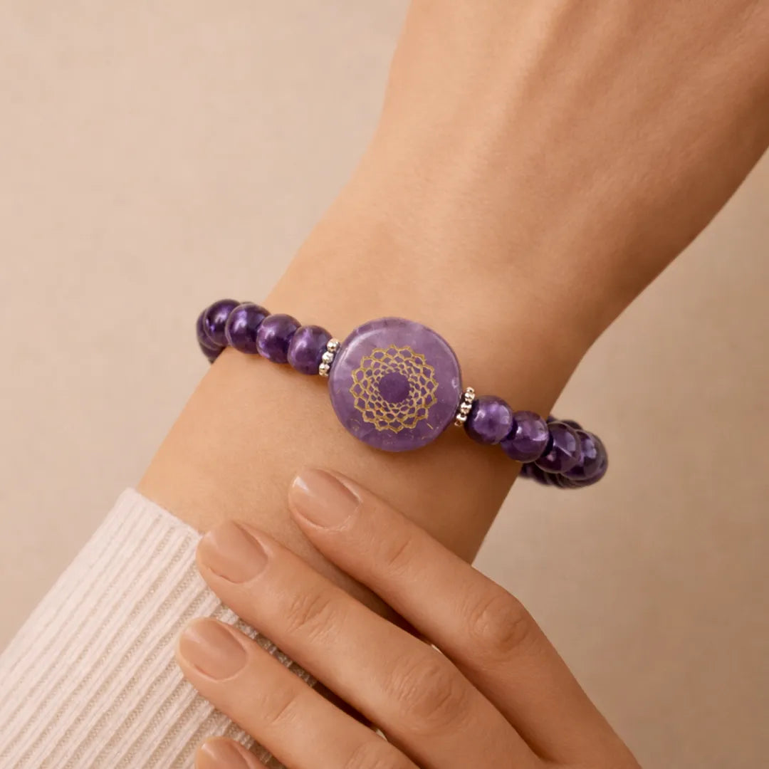 Purple beaded bracelet with a circular design on a wrist against a beige backgroundAmethyst Crown Chakra Bracelet – Abhimantrit & Energized