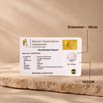 Identification report card from Precise Gemological Laboratory on a stone surface with measurements indicated.