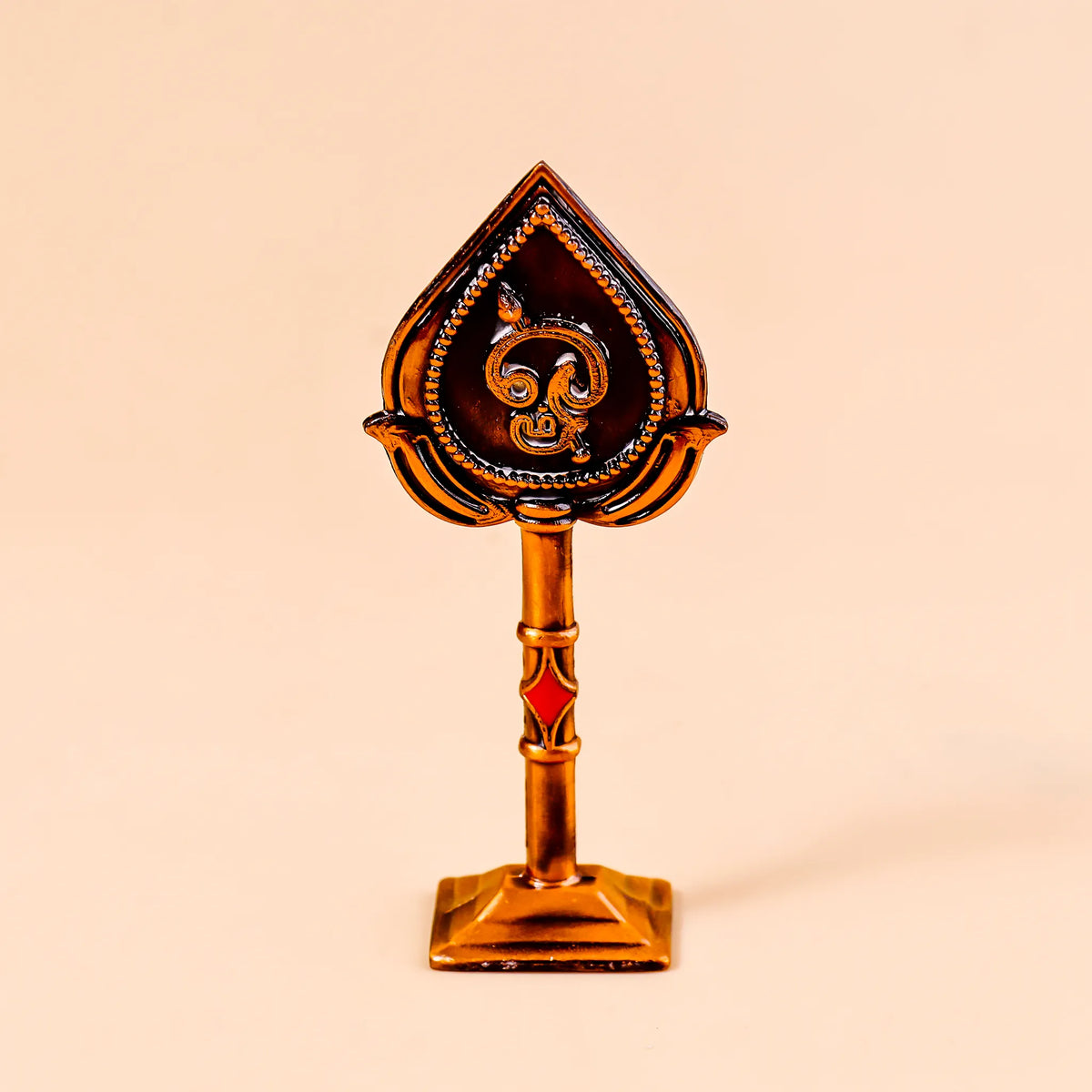 Decorative object with a spade design on a beige background
