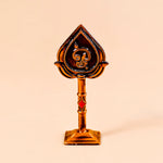 Decorative object with a spade design on a beige background