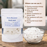 Aura Booster Bath Salt packaging with a bowl of bath salts on a wooden surface