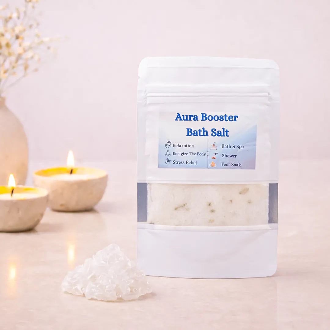 Aura Booster Bath Salt packaging with candles and a decorative vase on a light background