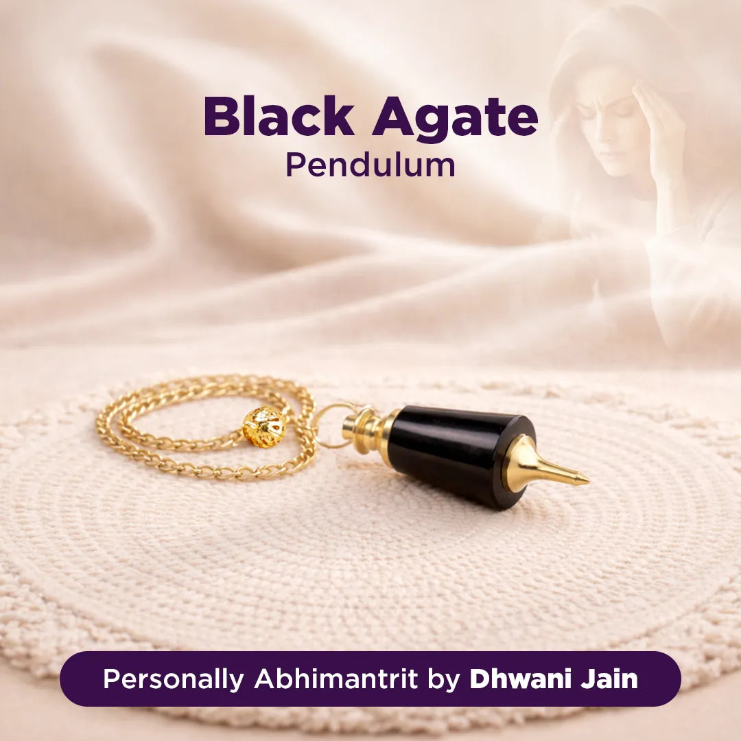 Black agate pendulum on a gold chain with a soft beige background