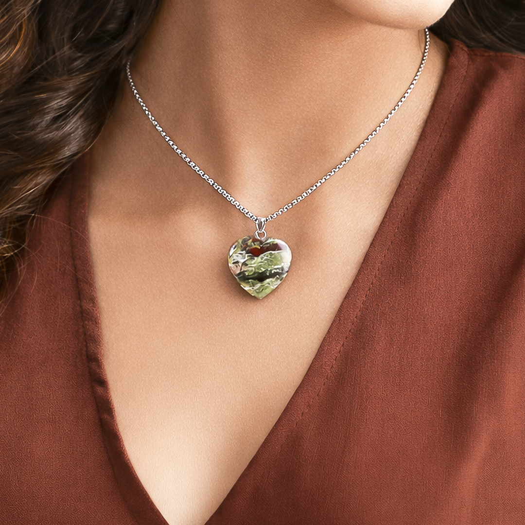 Heart-shaped pendant necklace on a model wearing a brown top