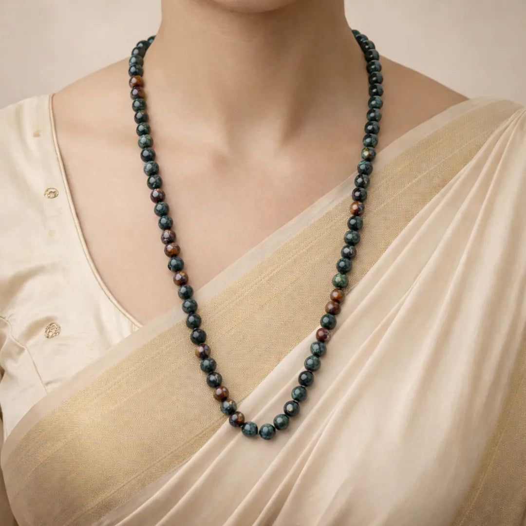 Person wearing a long beaded necklace with a neutral backgroundBloodstone Necklace for Strength, Protection & Confidence