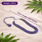 Purple beaded necklace with measurements on a beige background with green leaves.