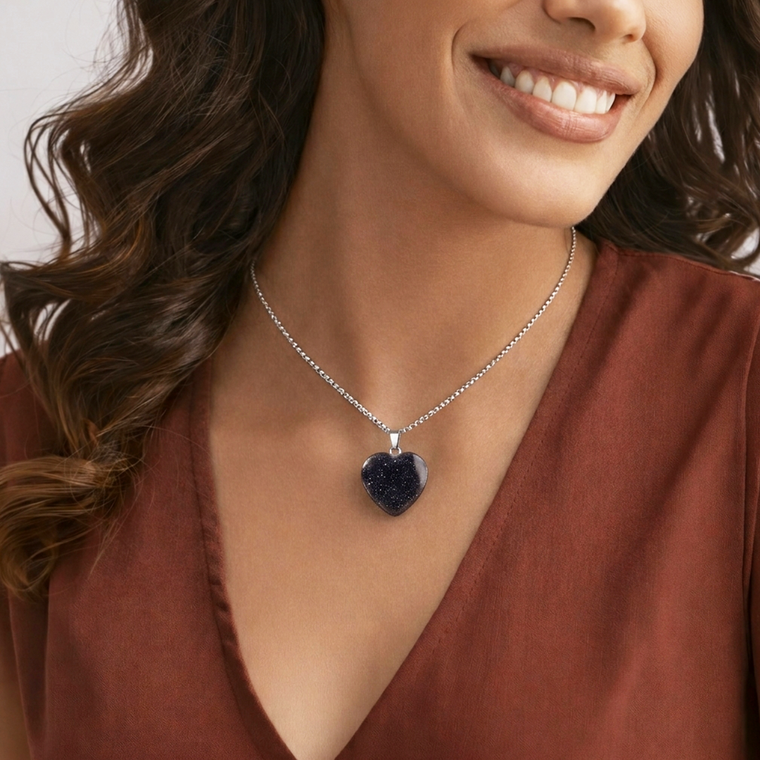 Woman wearing a necklace with a heart-shaped pendantBlue Sunstone Heart Pendant (Abhimantrit) for Confidence & Positivity