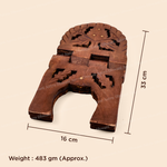 A brown carved wooden decorative object with cutout floral details, shown on a light beige background with dimension lines indicating 33 cm height, 16 cm width, and weight noted as 483 gm (Approx.).