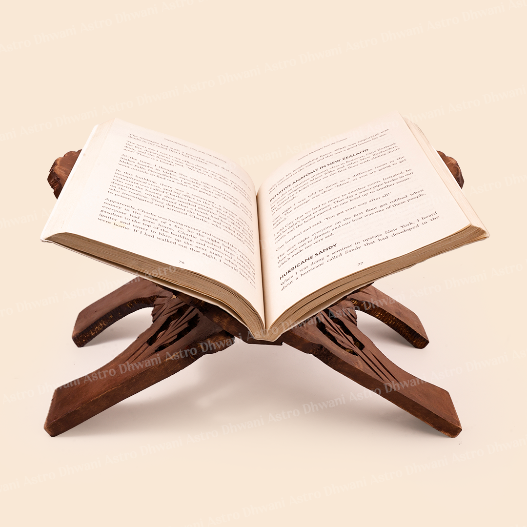 A dark brown carved wooden book stand holding an open book, set against a solid light beige background.