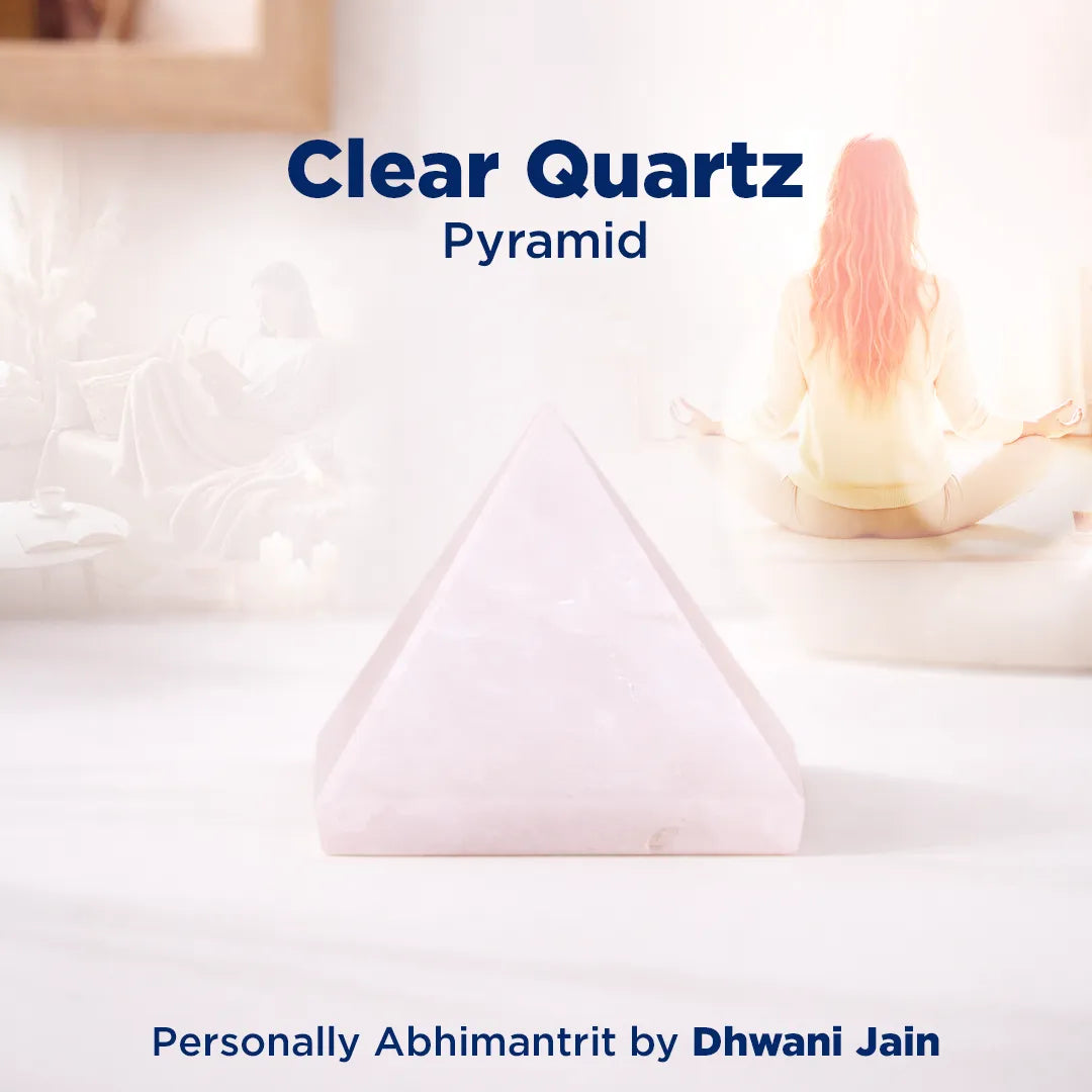 Clear quartz pyramid on a white surface with soft focus background