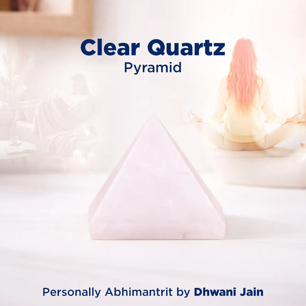 Clear quartz pyramid on a white surface with soft focus background
