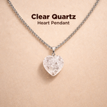 Clear quartz heart pendant necklace on a beige background