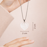 Heart-shaped pendant necklace with measurements on a plain background