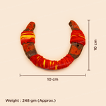 A U-shaped horn or antler accessory wrapped in red and yellow fabric, shown on a light beige background with dimension lines indicating 10 cm width and height, plus a weight note of 248 gm (approx.) at the bottom.
