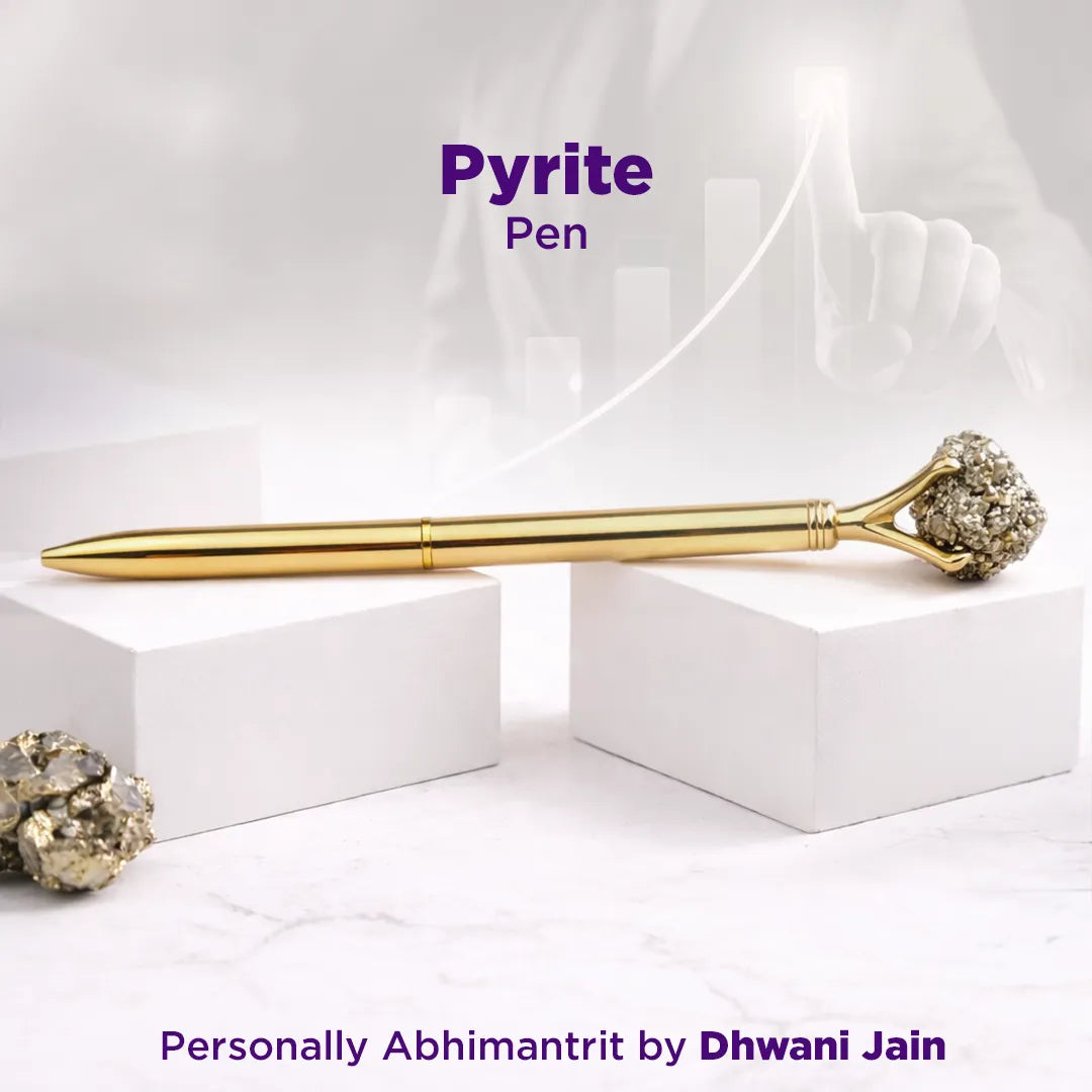 Gold pen with pyrite on a white background, featuring the brand 'Dhwani Jain'.