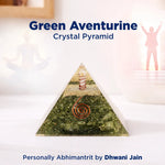 Green aventurine crystal pyramid on a white surface with text indicating the brand and product name.