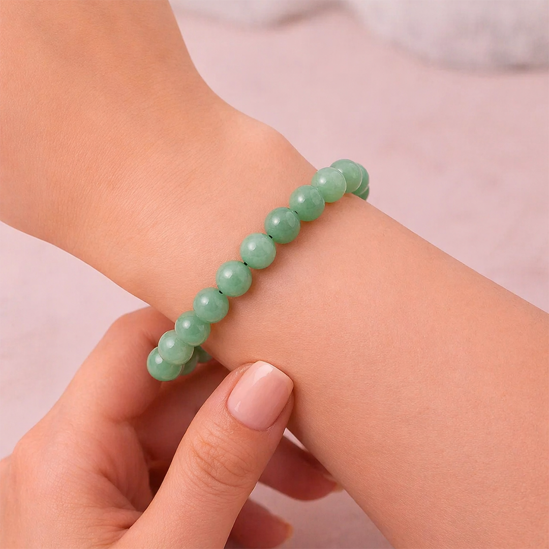 Green beaded bracelet on a wrist with a blurred backgroundPromotes Wealth Attraction & Money Growth: Green Aventurine Bracelet - Abhimantrit & Certified