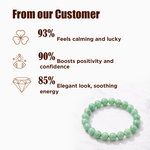 Green beaded bracelet with customer feedback on a white background