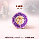 Guruji sticker with a purple border featuring an image of a person holding a child, on a light pink background.