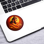 Laptop with a sticker of a religious figure on the palm rest area