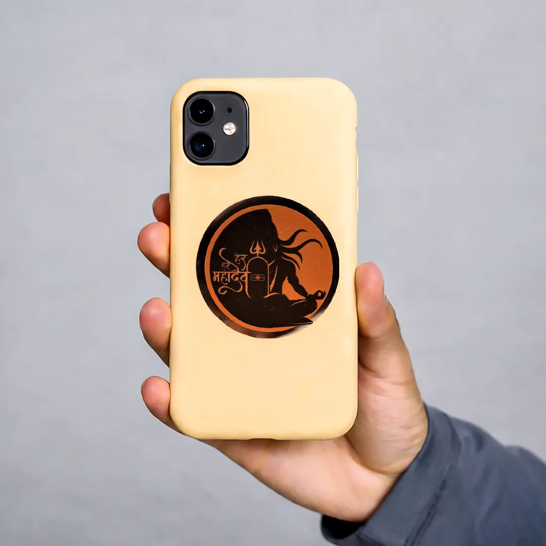 Hand holding a phone case with a design on a gray background