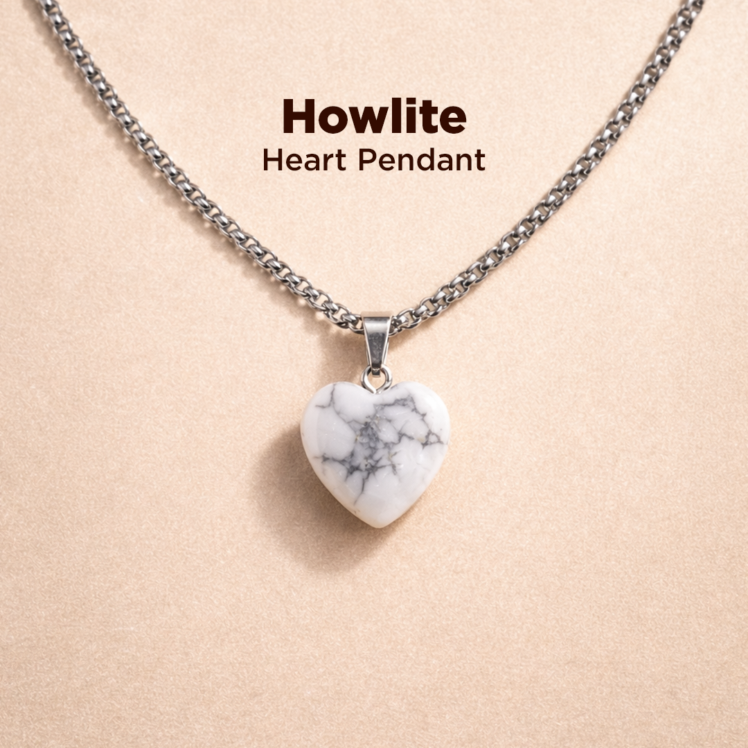 Howlite heart pendant necklace on a beige background