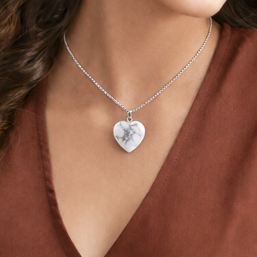 Heart-shaped pendant necklace on a person wearing a brown topHowlite Heart Pendant (Abhimantrit) for Calmness & Emotional Balance
