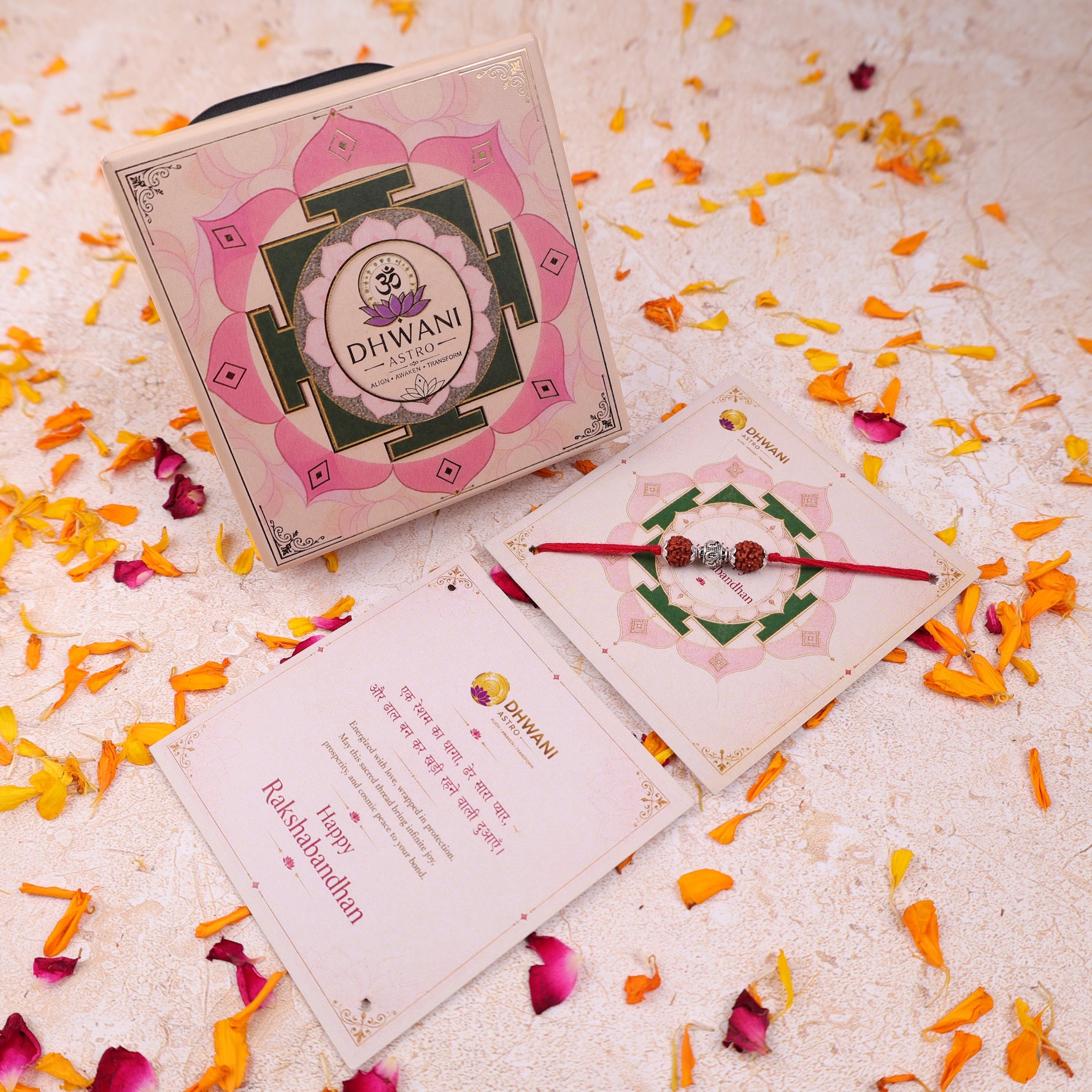 A boxed Rakhi gift set with a pink and green lotus-patterned box, a red beaded Rudraksha Rakhi with 925 silver OM Symbol with a red thread The box and cards show the brand name Dhwani Astro.925 Sterling Silver 5 Mukhi Rudraksha Rakhi, Spiritually Energized Raksha Bandhan Bracelet for Brother