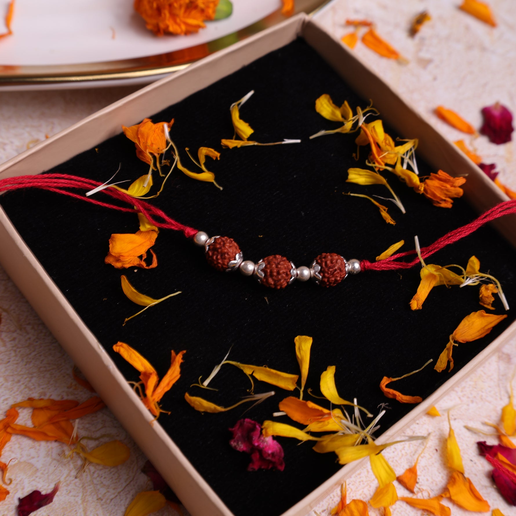 925 Sterling Silver Triple 5 Mukhi Rudraksha Rakhi presented in a premium gift box with traditional red thread for Raksha Bandhan.925 Sterling Silver 5 Mukhi Rudraksha Rakhi, Spiritually Energized Raksha Bandhan Bracelet for Brother