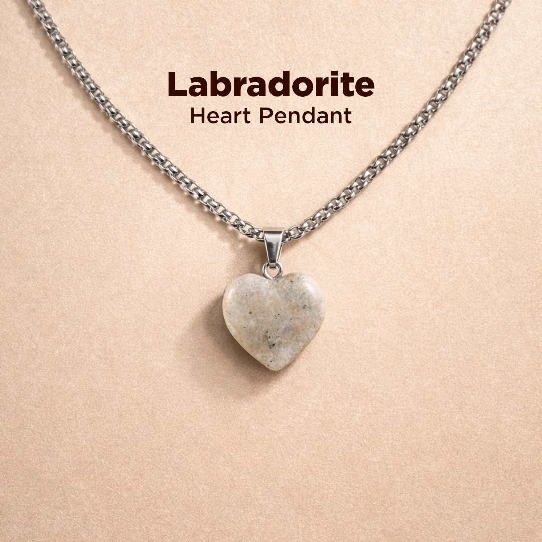 Labradorite heart pendant necklace on a beige background