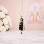 Decorative pendant with a blurred background of flowers and a statue.