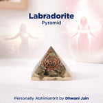 Labradorite pyramid with a spiral design on a white background, featuring the brand 'Dhwani Jain'.