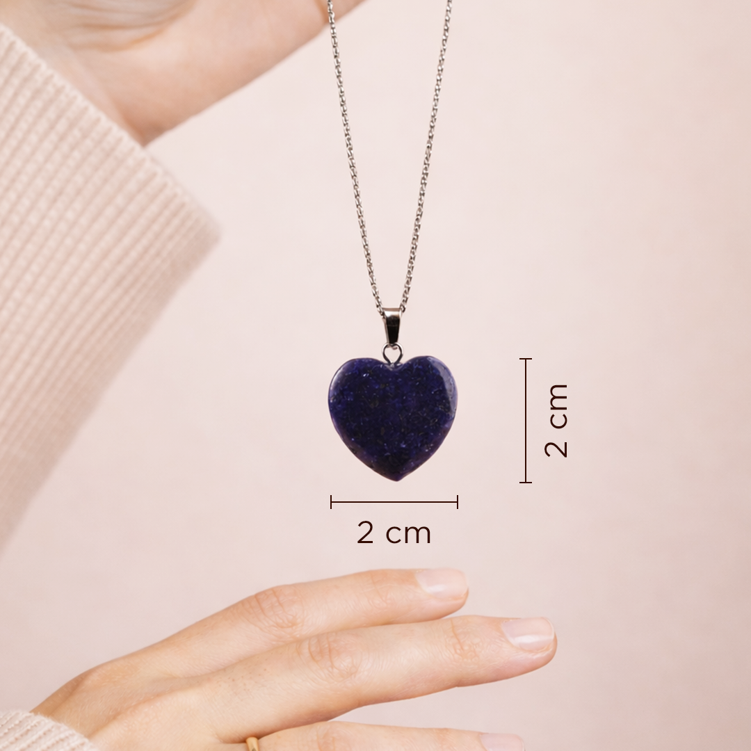 Heart-shaped purple pendant on a chain with measurements against a beige background