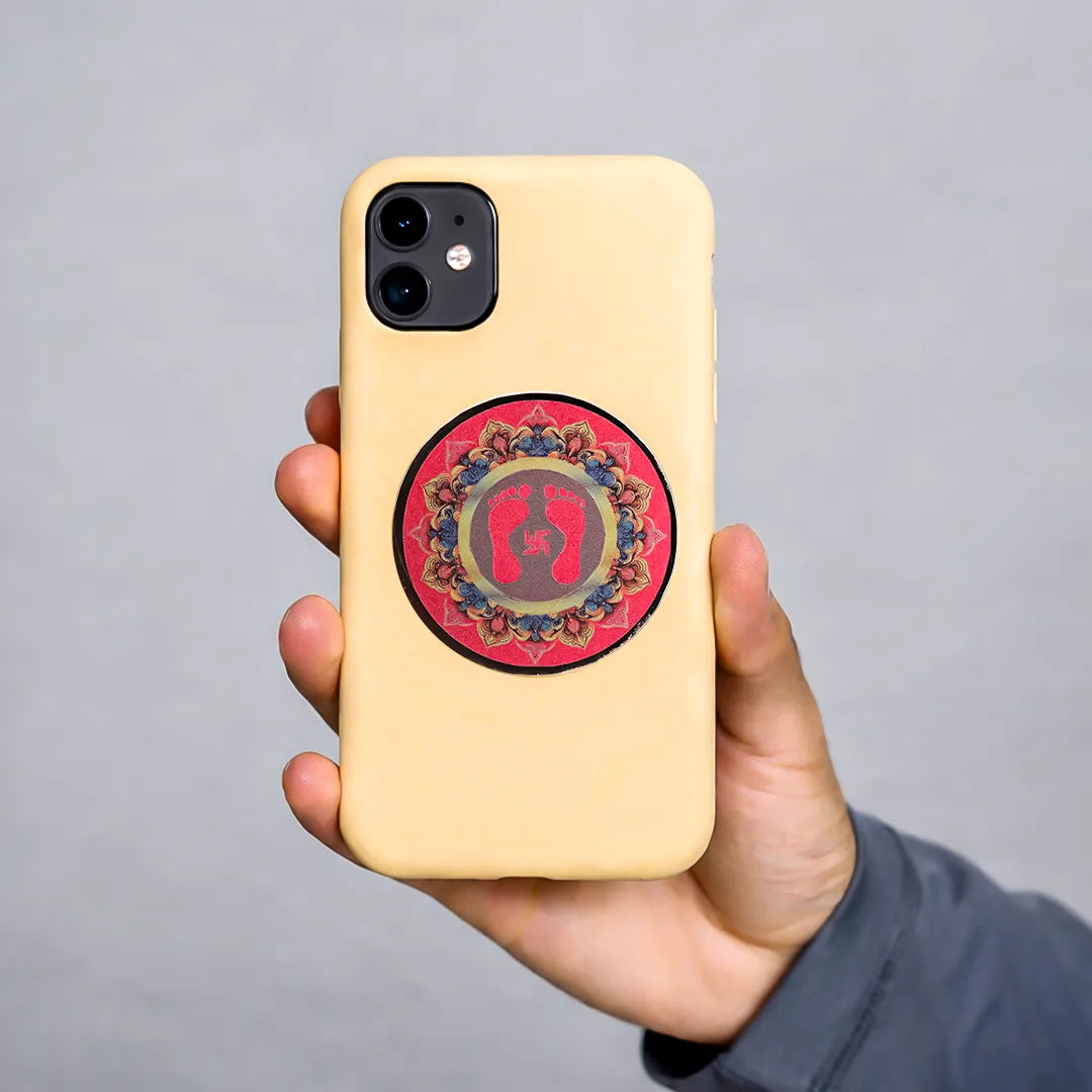Hand holding a beige phone case with a colorful circular design on a gray backgroundGoddess Laxmi Feet Sticker (Pack of 10pcs) - Lakshmi Charan