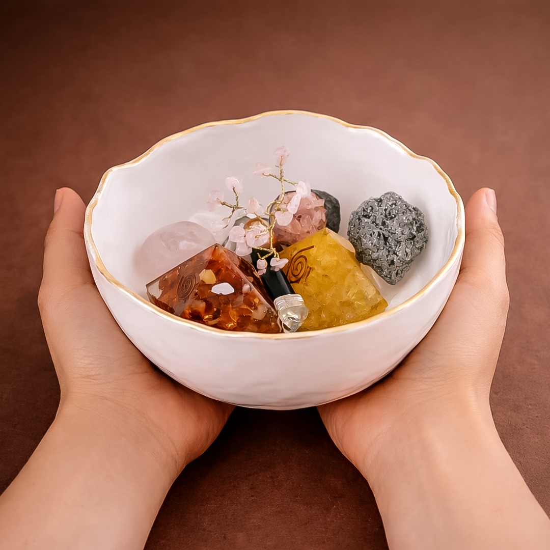 White bowl with crystals held by hands against a brown background