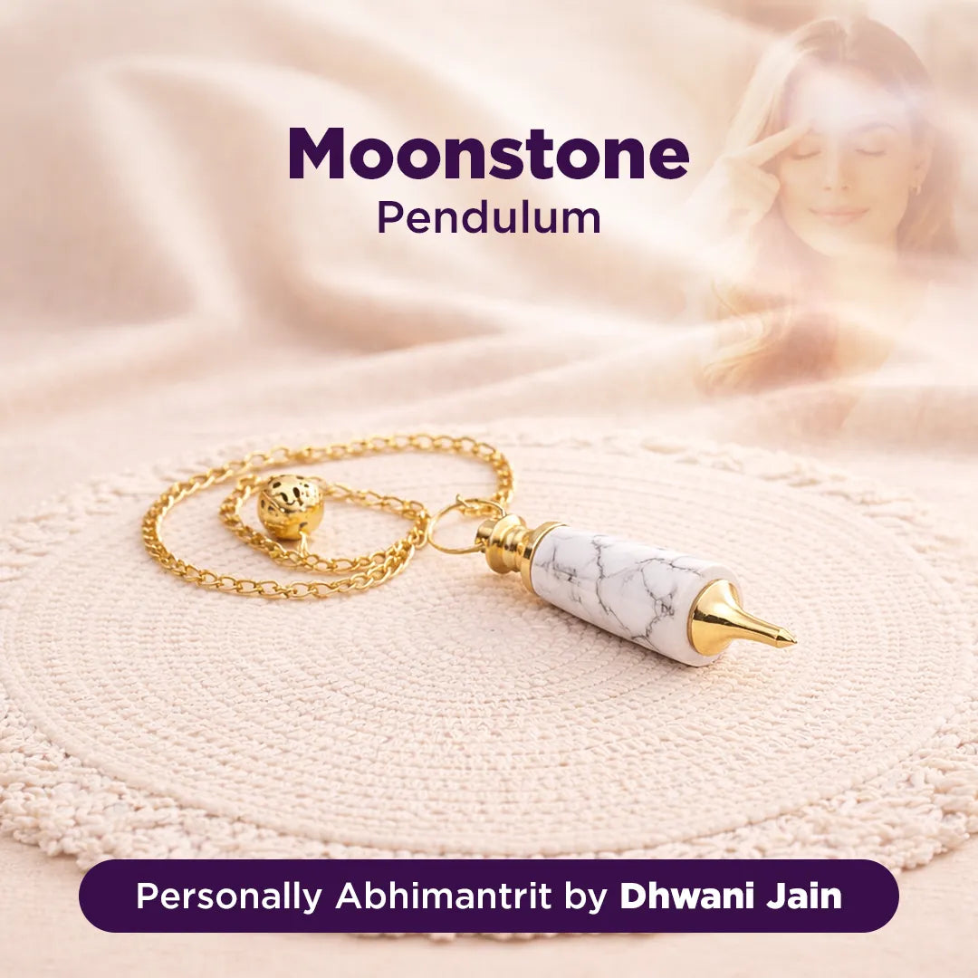 Moonstone pendulum with gold chain on a soft fabric background, branded as 'Personally Abhimantrit by Dhwani Jain'.